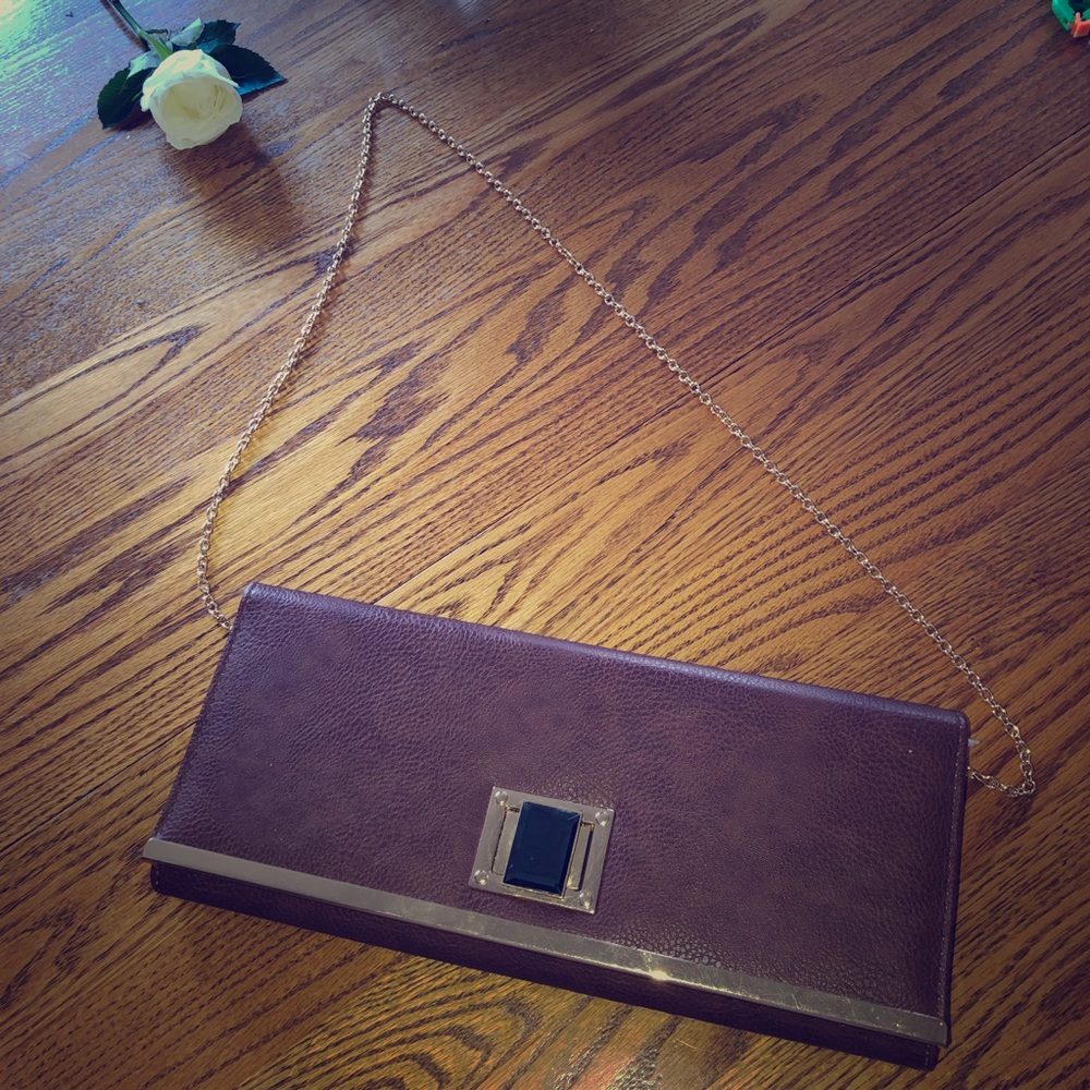 New brown leather clutch with cold accents